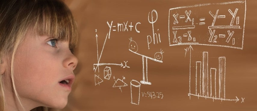 child looking at math rules on a chalk board