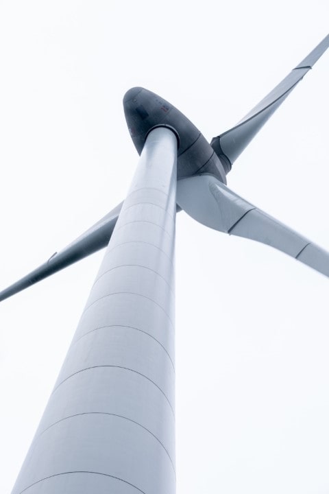 looking up at a wind turbine