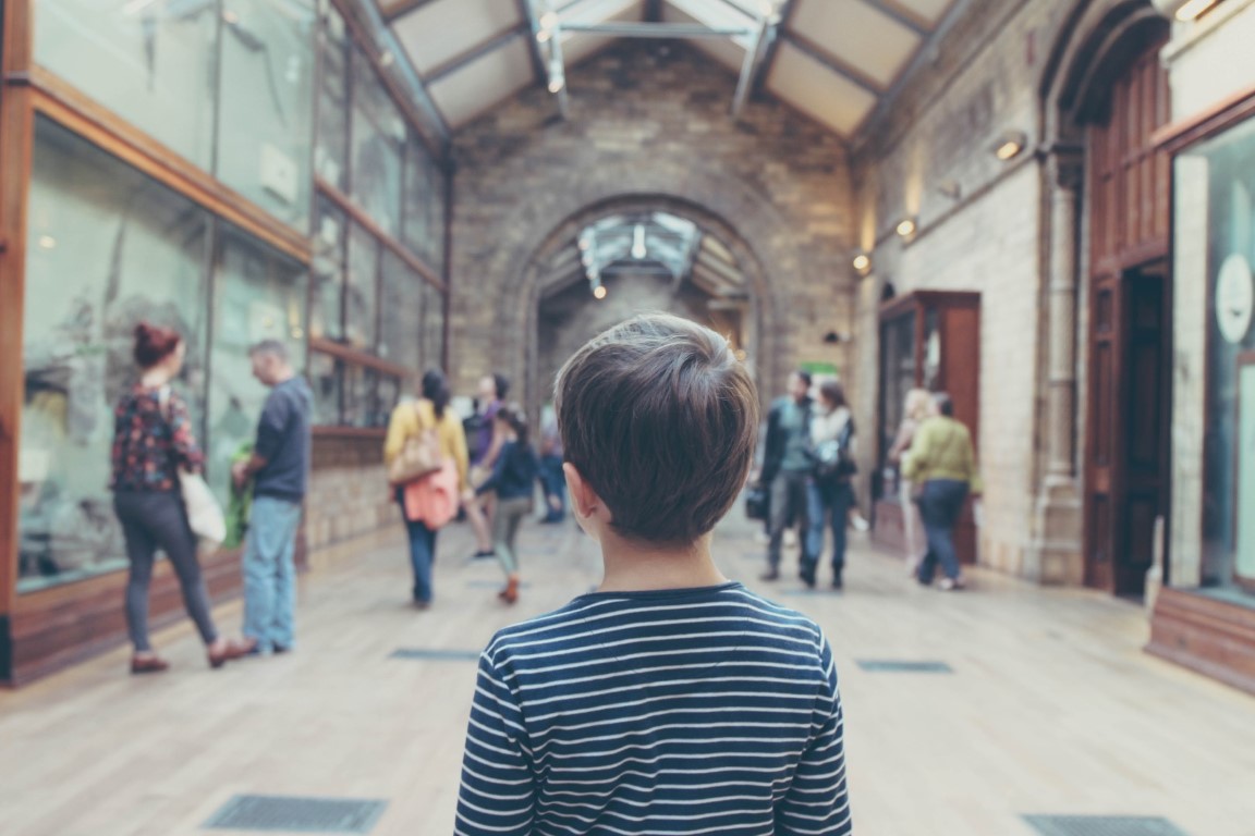 big image of a boy looking at a hall with exhibits